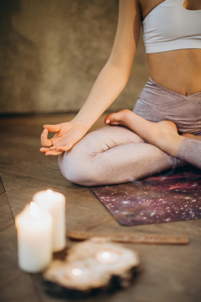 pexels photo 3822621 3822621 A woman practicing yoga indoors in lotus pose with candles creating a calming atmosphere.